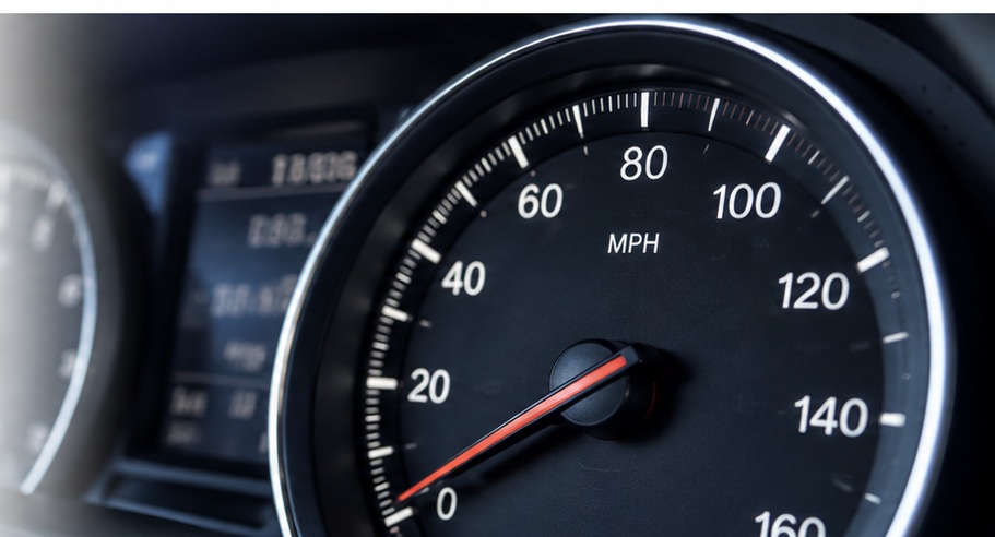 Close-up of a modern automobile dashboard with an analog MPH speedometer