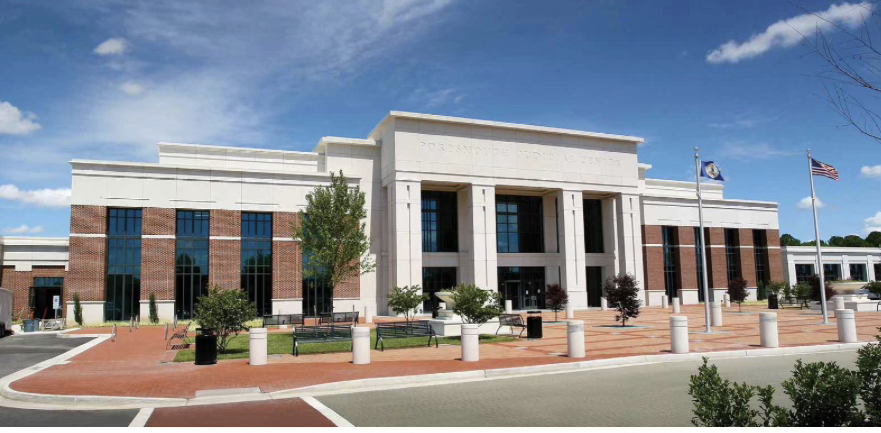 Portsmouth Judicial Center with its stone entrance, brick wings, and Virginia and United States flags